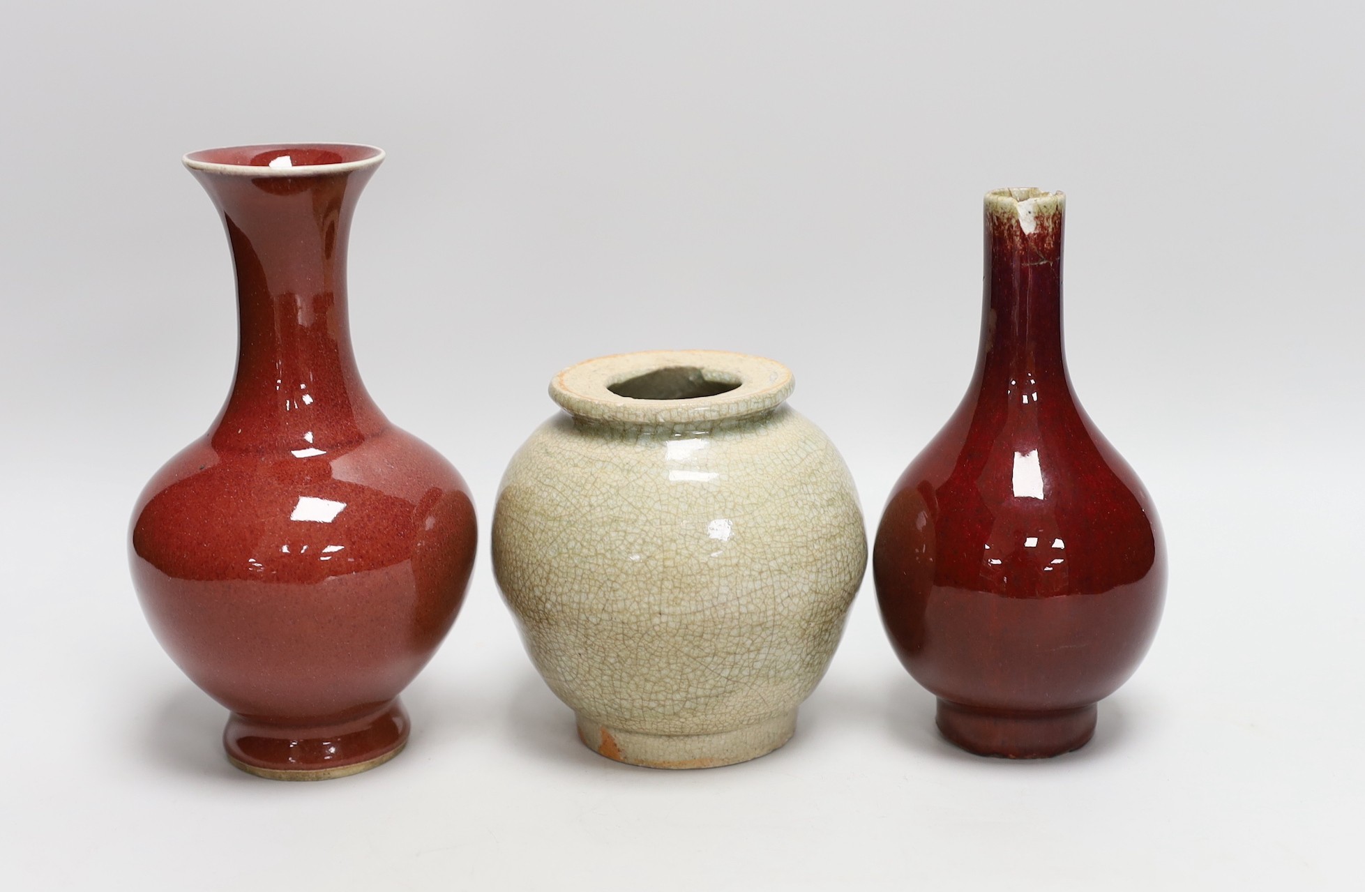 Two Chinese sang de boeuf vases and a crackle glaze jar, tallest 17cm